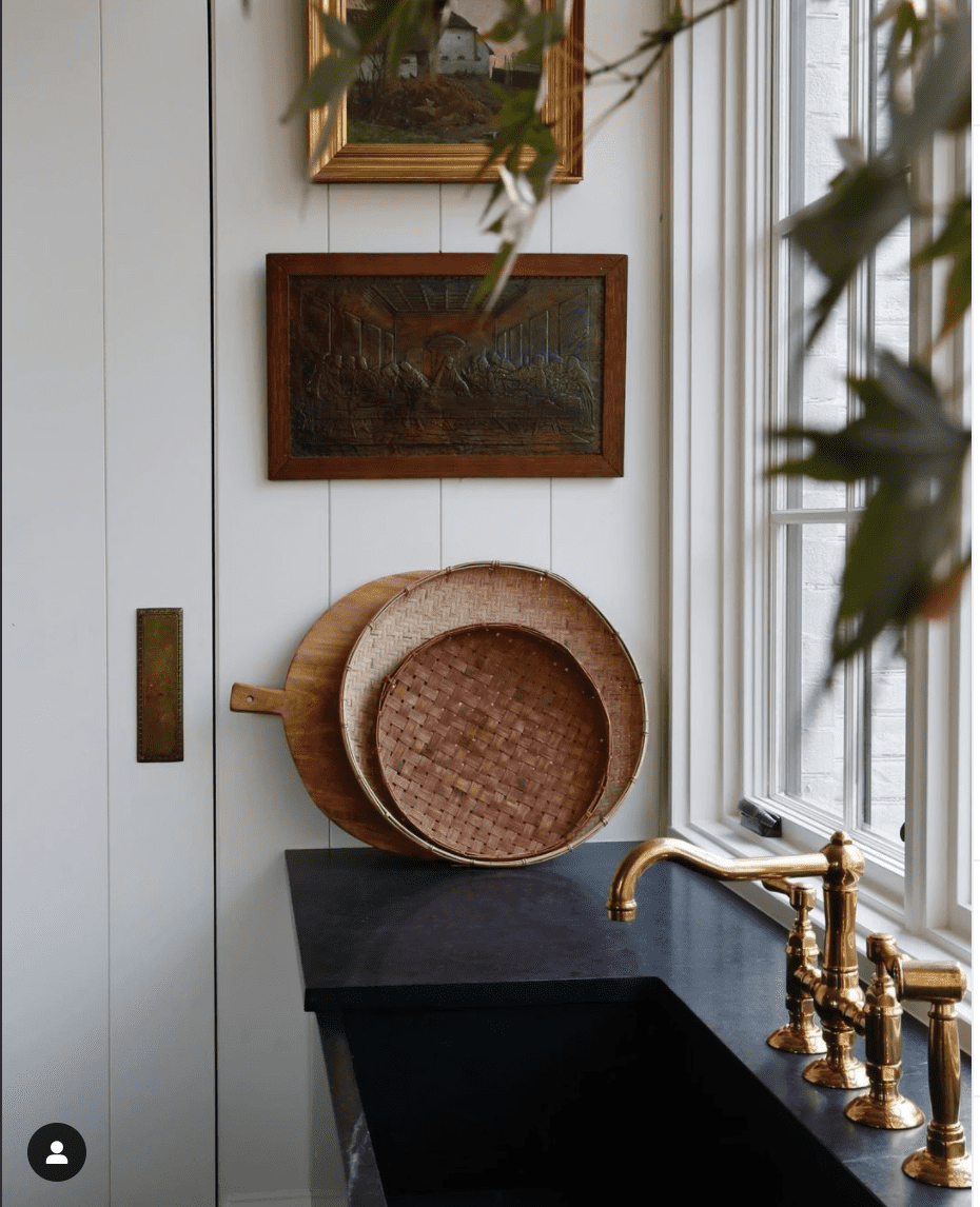 kitchen sink with vintage decorative photo frames and gold tap