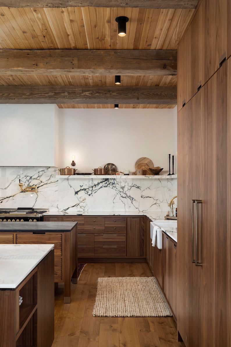 luxurious stained wood kitchen with marble backsplash